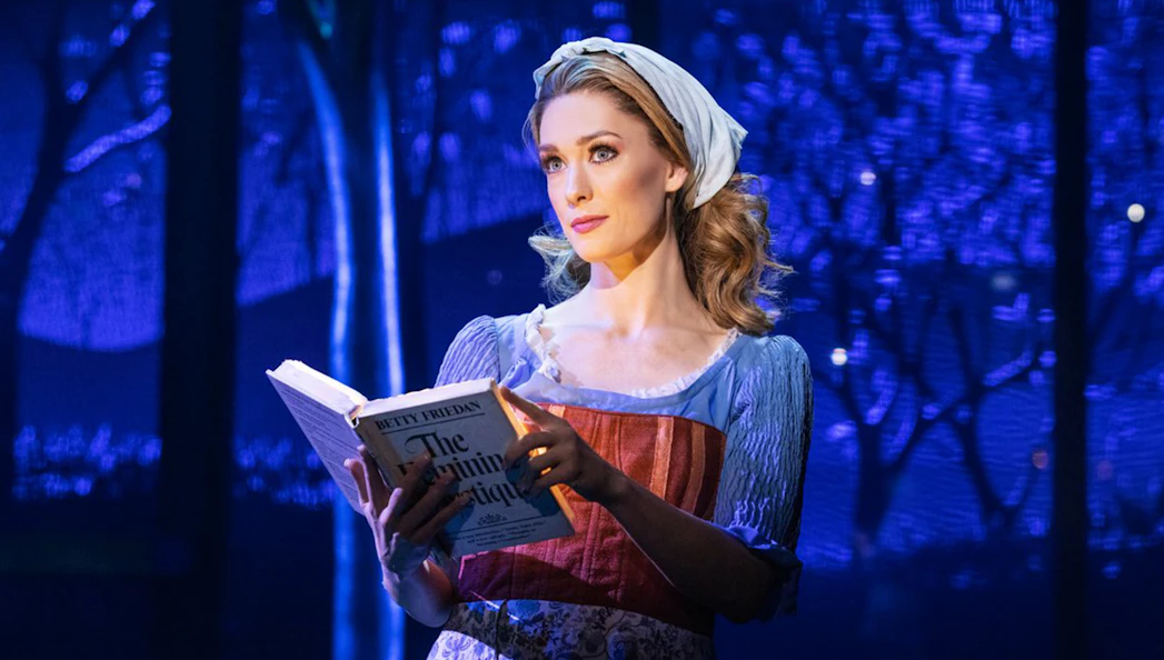 Performer reading a book on stage during "Once Upon a One More Time" show.