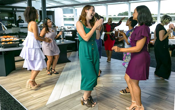 Guests dancing on a New York Signature Dinner Cruise.