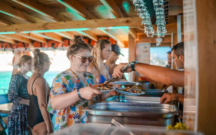 Guests serving lunch on Alanya Boat Day Tour.