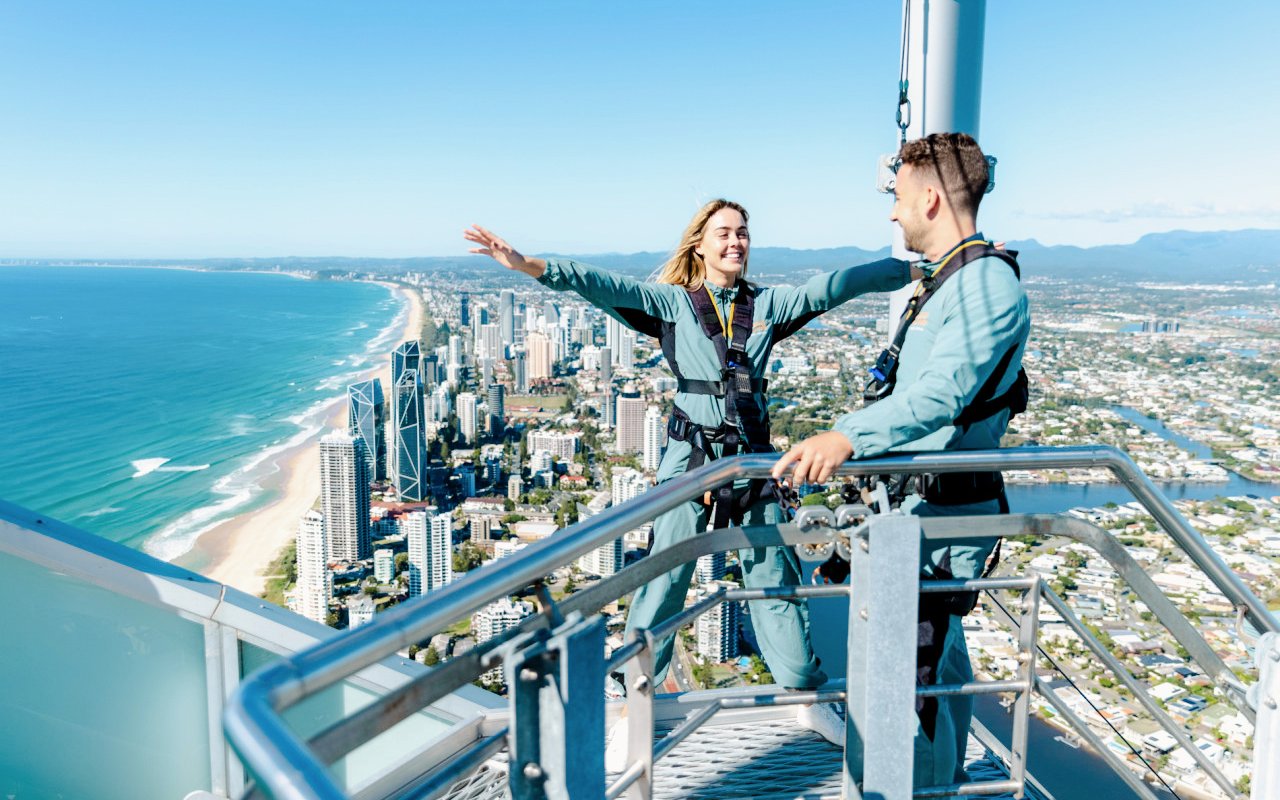 Girl enjoying SkyPoint Climb with view of Gold Coast skyline and ocean.