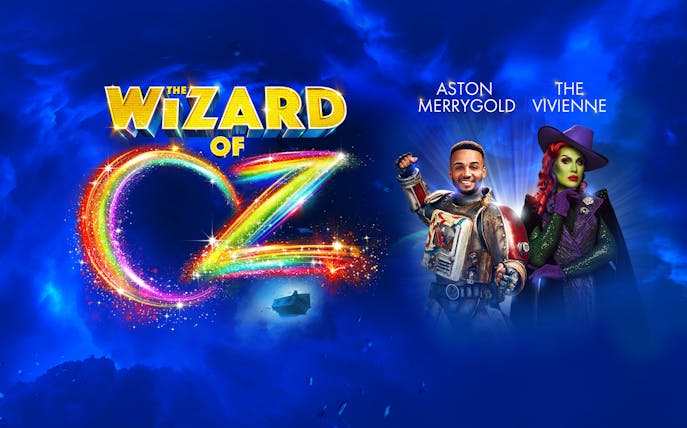Wizard of Oz logo with two characters in colorful costumes against a blue sky background.