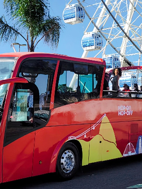 Rio de Janeiro hop-on hop-off bus near Ferris wheel.