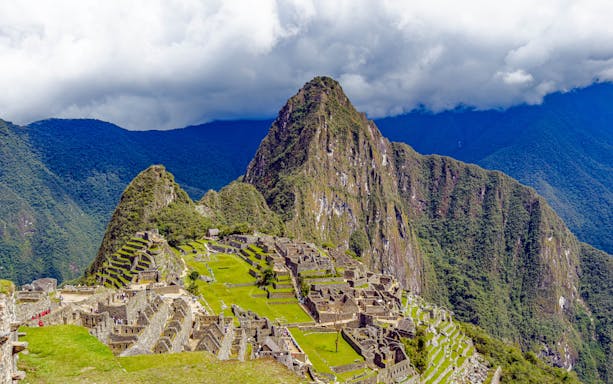 Aerial view of Machu Picchu ruins with Huayna Picchu mountain in Peru.