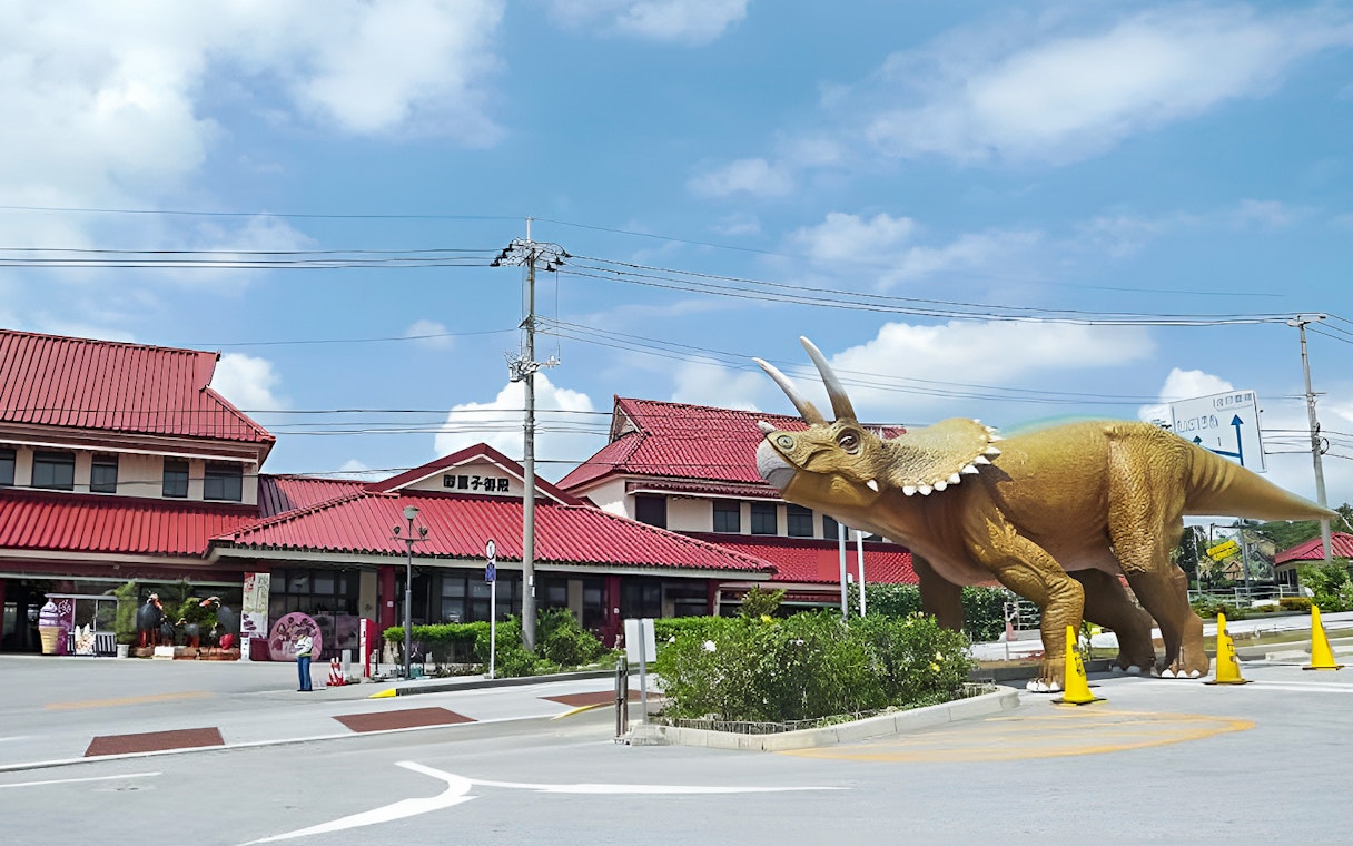 Triceratops statue at Dino Park Yanbaru Subtropical Forest entrance in Okinawa.