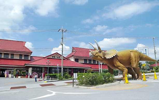 Triceratops statue at Dino Park Yanbaru Subtropical Forest entrance in Okinawa.