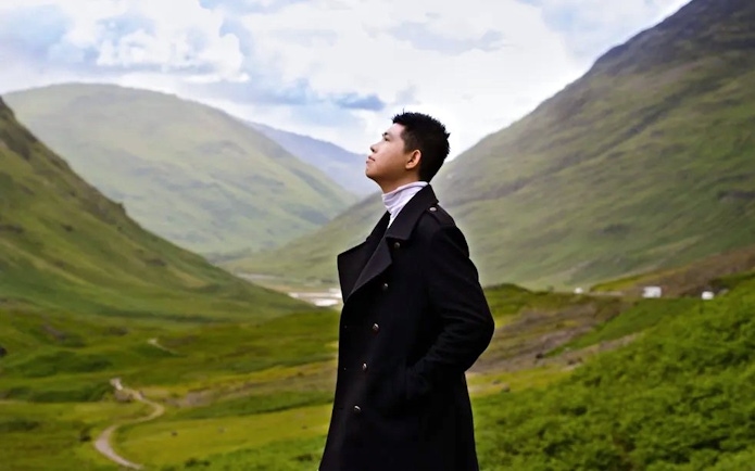 Tourist admiring the scenic valley of Glen Coe, Scotland.