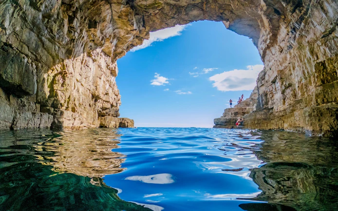 Golubinka Sea Cave in Croatia with clear blue water and rocky arch.