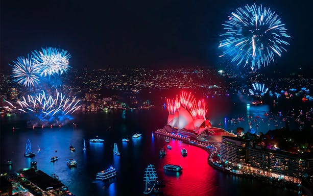 Sydney Harbour fireworks over Opera House during New Year's Eve cruises.