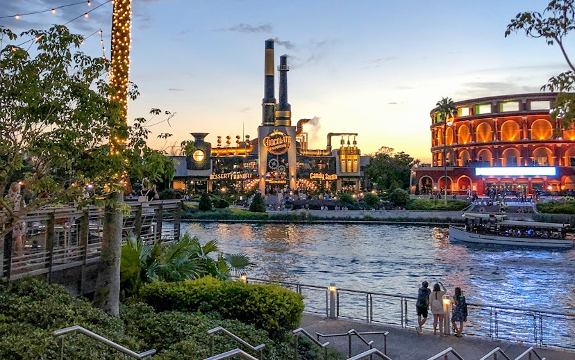 Toothsome Chocolate Emporium across the lake at sunset, Universal Orlando, Florida.