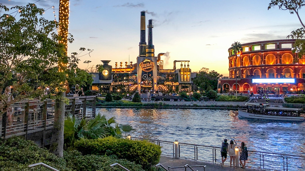 Toothsome Chocolate Emporium across the lake at sunset, Universal Orlando, Florida.