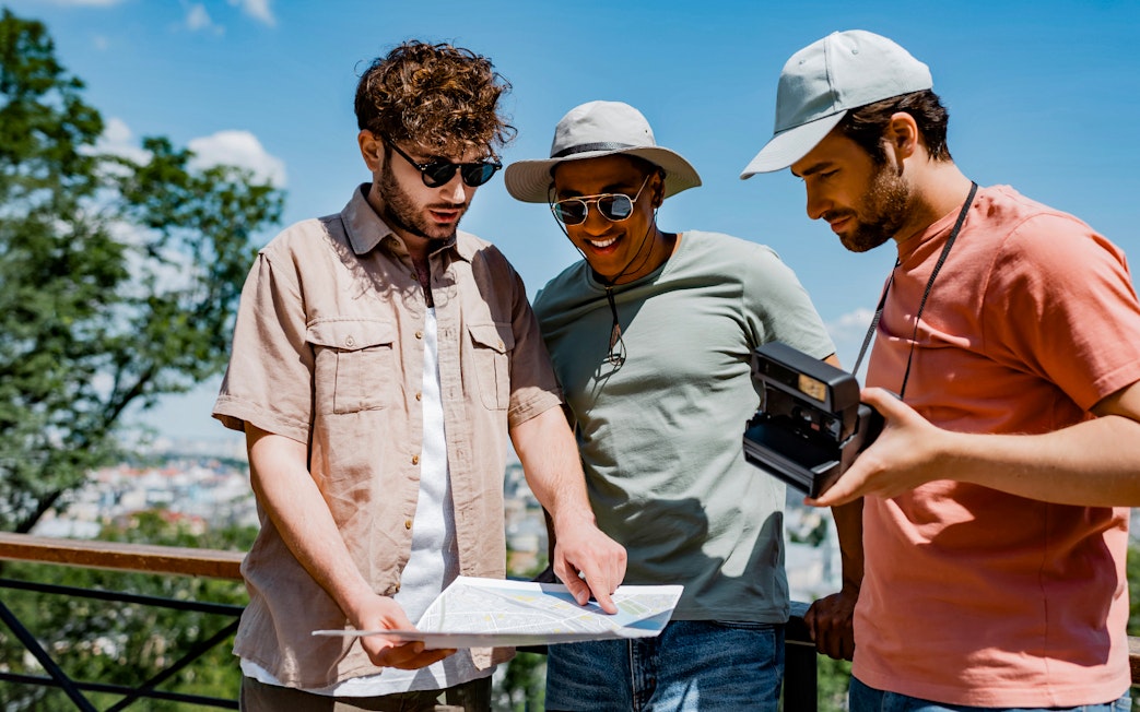 Tour guide explaining map to tourists during Toledo Monuments tour.