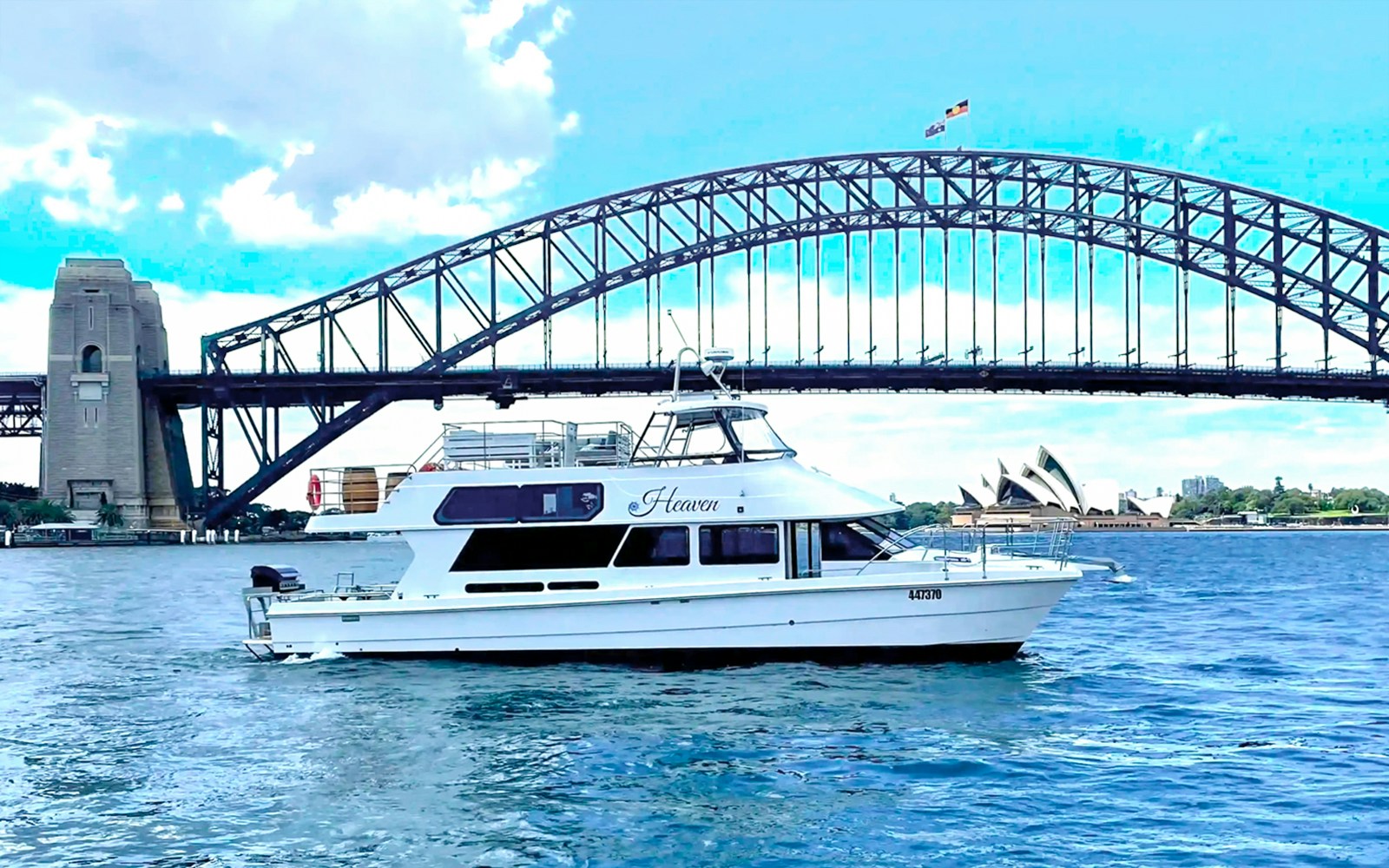 Heaven vessel cruising Sydney Harbour with Sydney Harbour Bridge in the background.