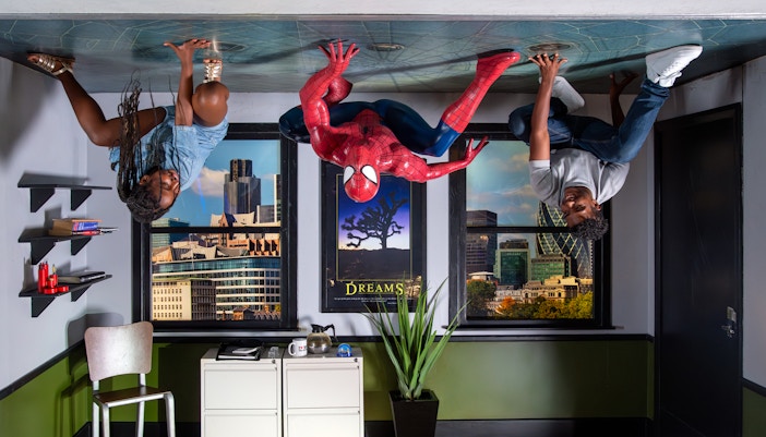 Spiderman figure with visitors on ceiling at Madame Tussauds London.