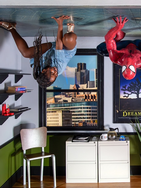 Spiderman figure with visitors on ceiling at Madame Tussauds London.