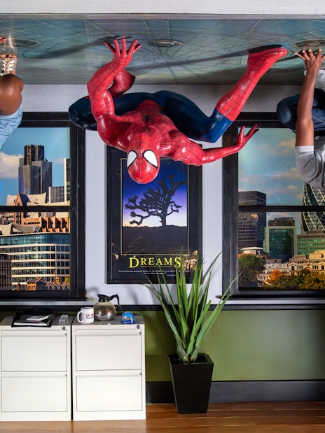 Spiderman figure with visitors on ceiling at Madame Tussauds London.