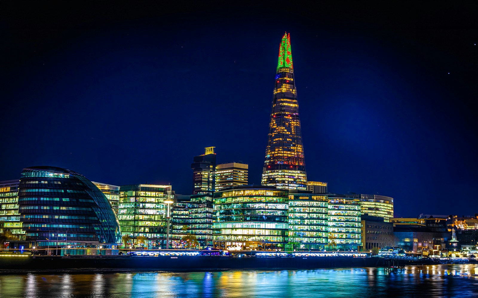 Christmas lights illuminate The Shard in London at night.
