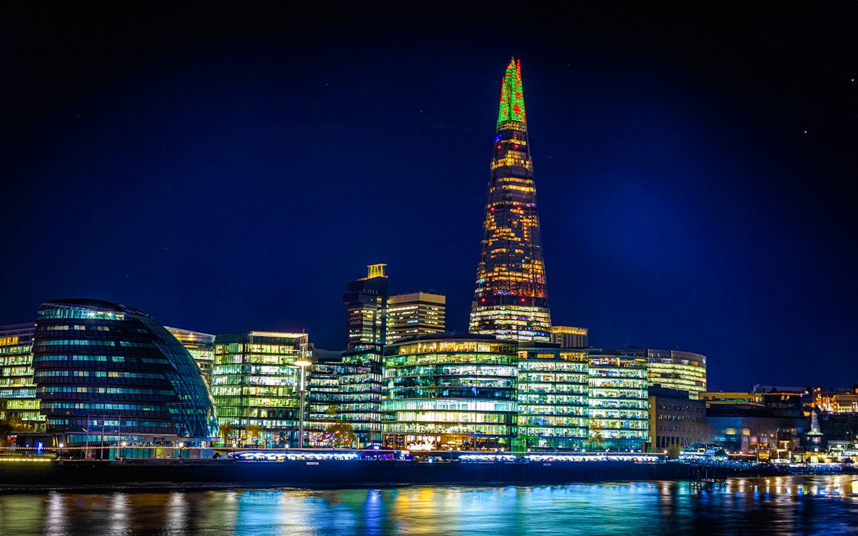 Christmas lights illuminate The Shard in London at night.