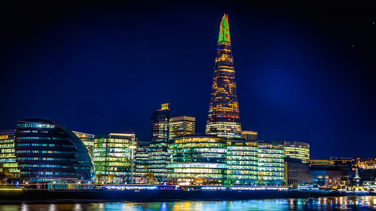 Christmas lights illuminate The Shard in London at night.