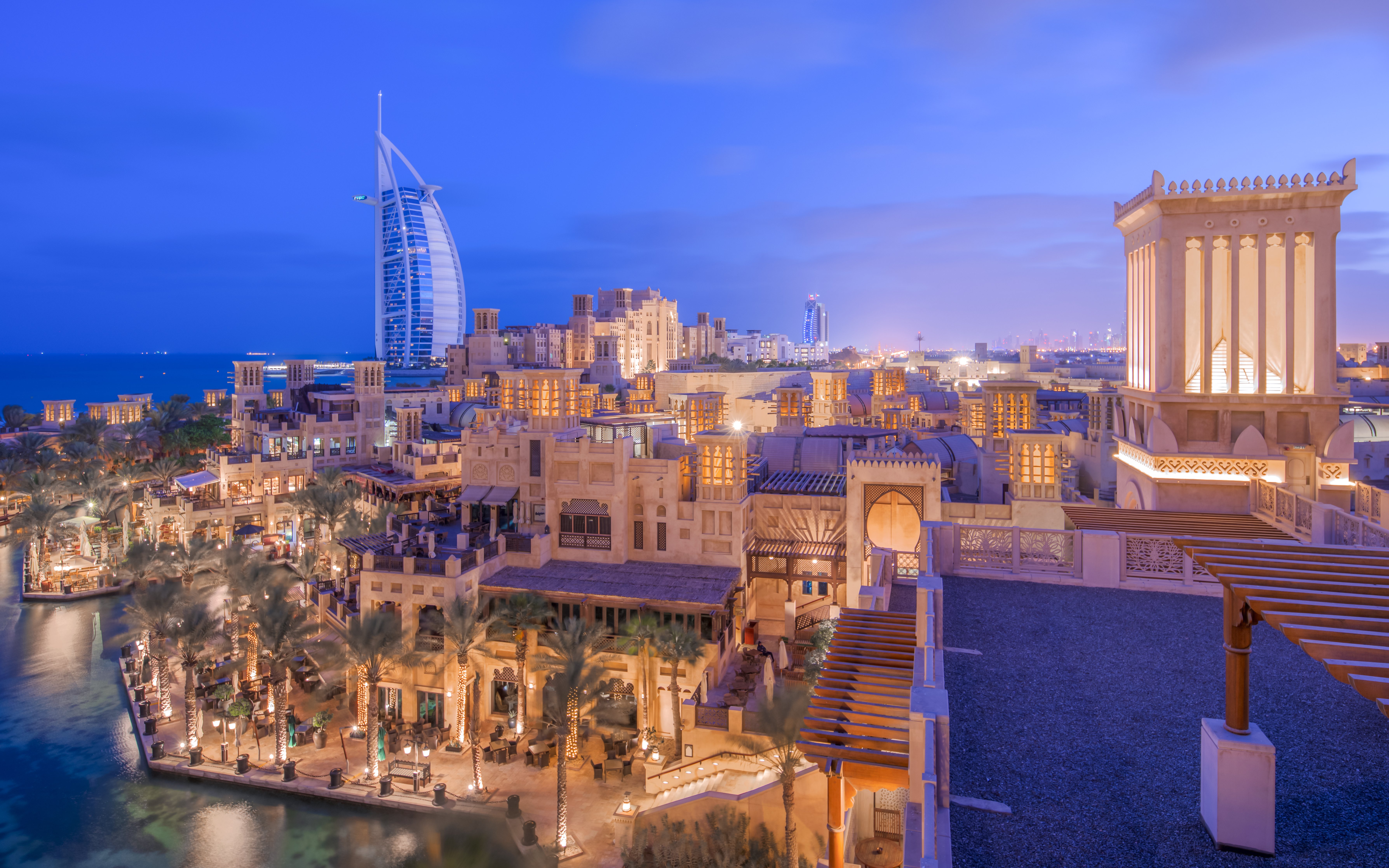 Madinat Jumeirah at night with Burj Al Arab in the background, Dubai.