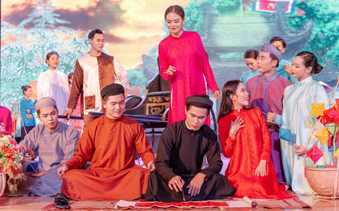 Performers in traditional Ao Dai costumes during a cultural show in Da Nang.