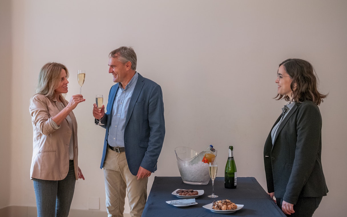 Tourists with guide enjoying snacks and drinks inside Casa Mila, Barcelona.