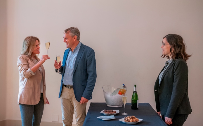 Tourists with guide enjoying snacks and drinks inside Casa Mila, Barcelona.