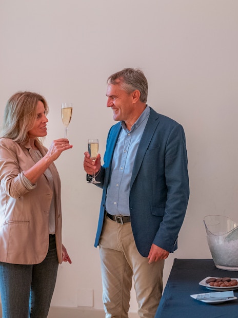 Tourists with guide enjoying snacks and drinks inside Casa Mila, Barcelona.