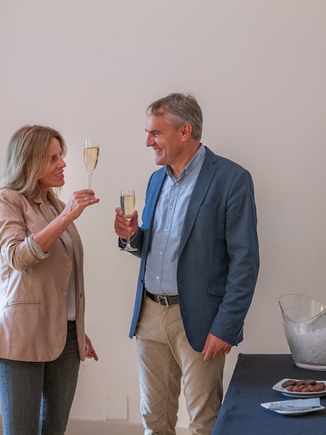 Tourists with guide enjoying snacks and drinks inside Casa Mila, Barcelona.