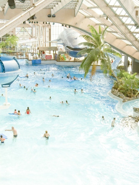 Indoor water park with slides and wave pool at Aquaboulevard de Paris.