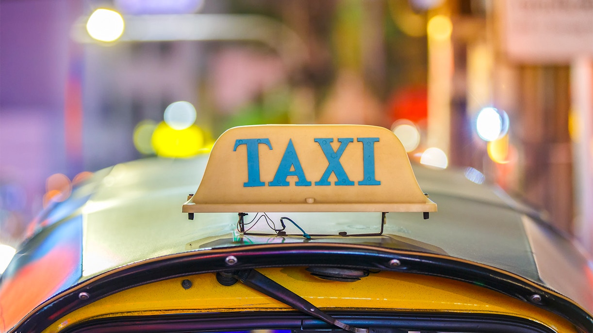 taxi sign illuminated at night.