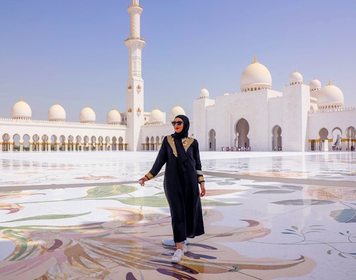 Lady walking at Sheikh Zayed Grand Mosque courtyard, Abu Dhabi.