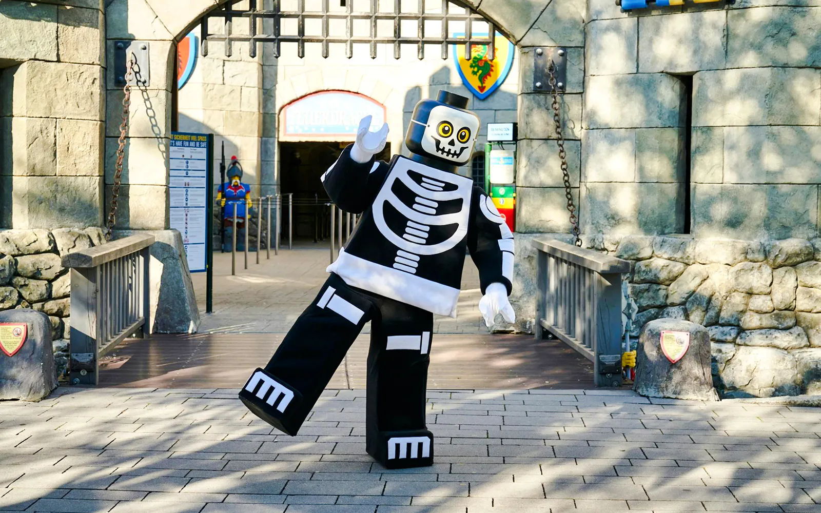 Lego skeleton character at Legoland Billund entrance during Halloween event.