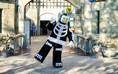 Lego skeleton character at Legoland Billund entrance during Halloween event.
