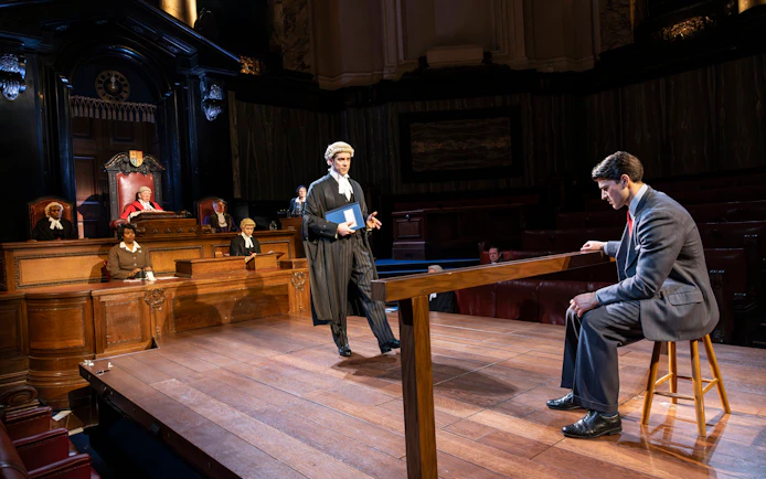 Courtroom scene from "Witness for the Prosecution" performance with actors in legal roles.