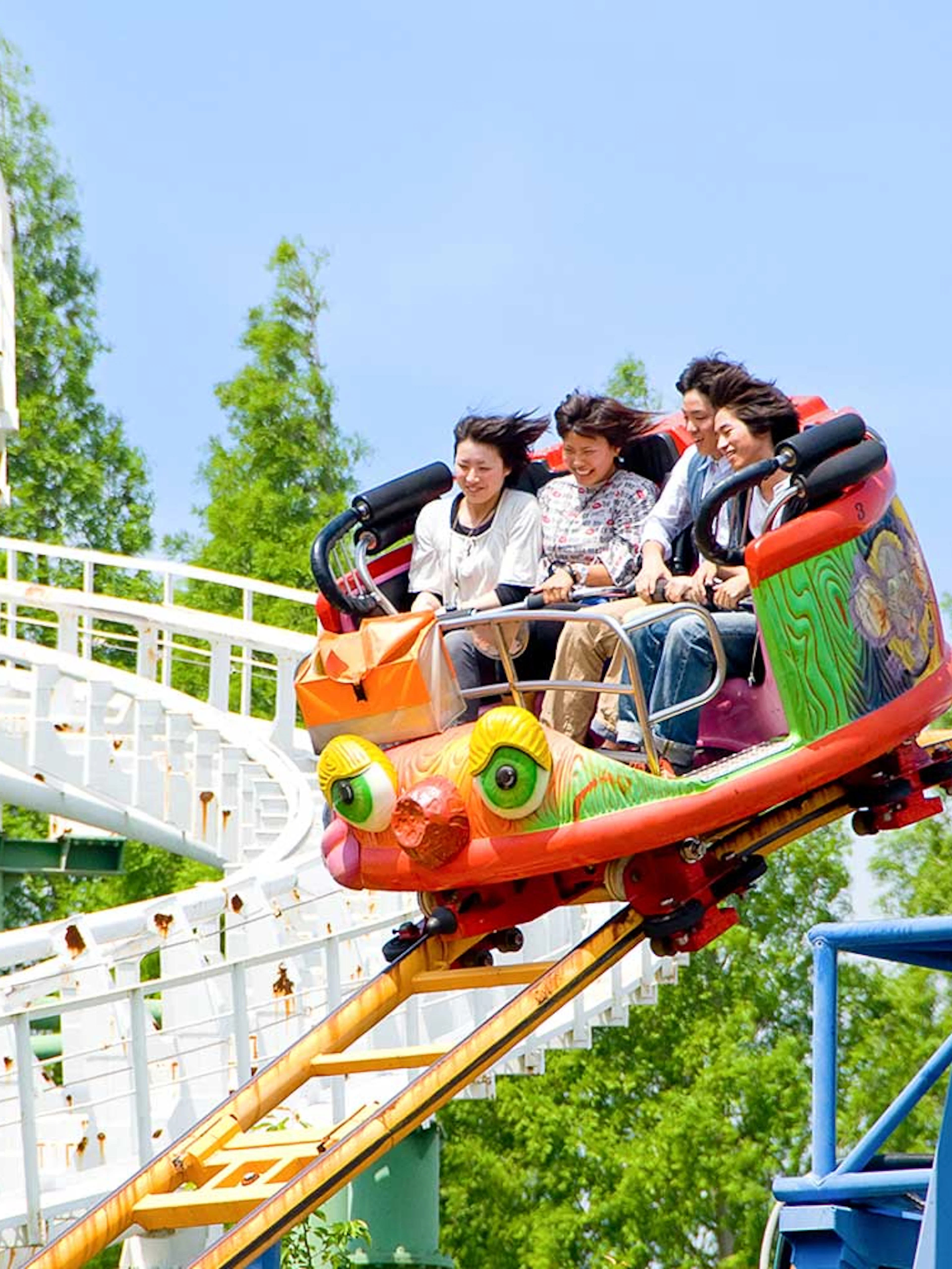 Roller coaster ride at Hirakata Park with passengers enjoying the thrill.