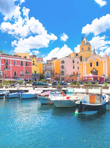 Boats docked in the harbor of colorful Procida Island, Campania, Italy.
