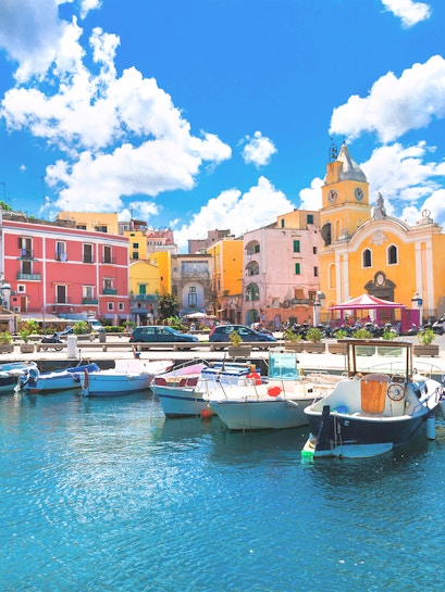 Boats docked in the harbor of colorful Procida Island, Campania, Italy.