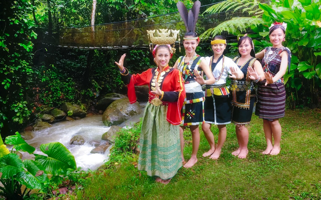 Traditional dancers in cultural attire at Mari Mari Cultural Village, Sabah, Malaysia.