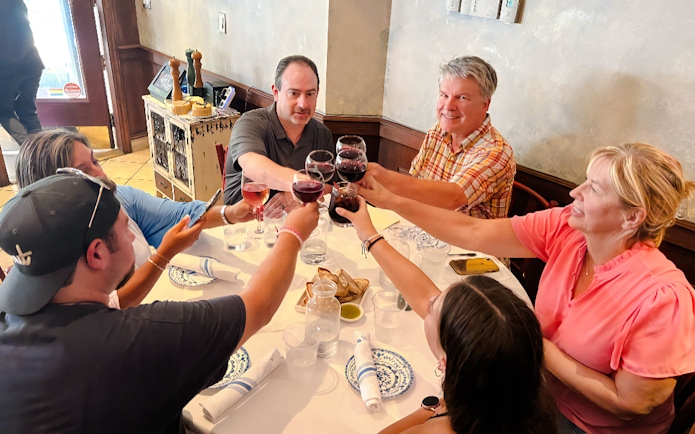 Tourists toasting with wine at Ahoy New York Food Tours.