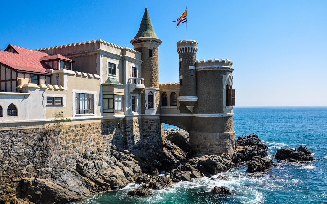 Wulff Castle on rocky coastline in Vina del Mar, Chile, with ocean view.
