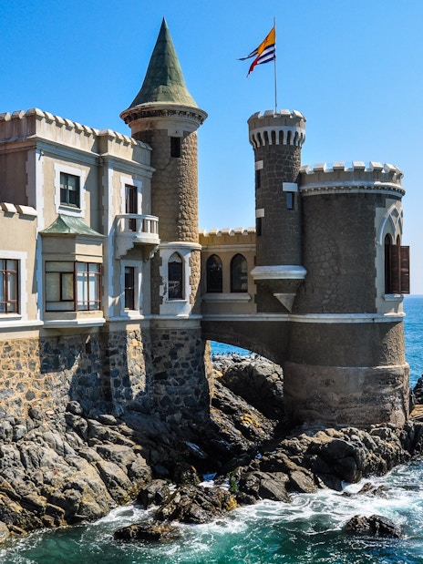 Wulff Castle on rocky coastline in Vina del Mar, Chile, with ocean view.