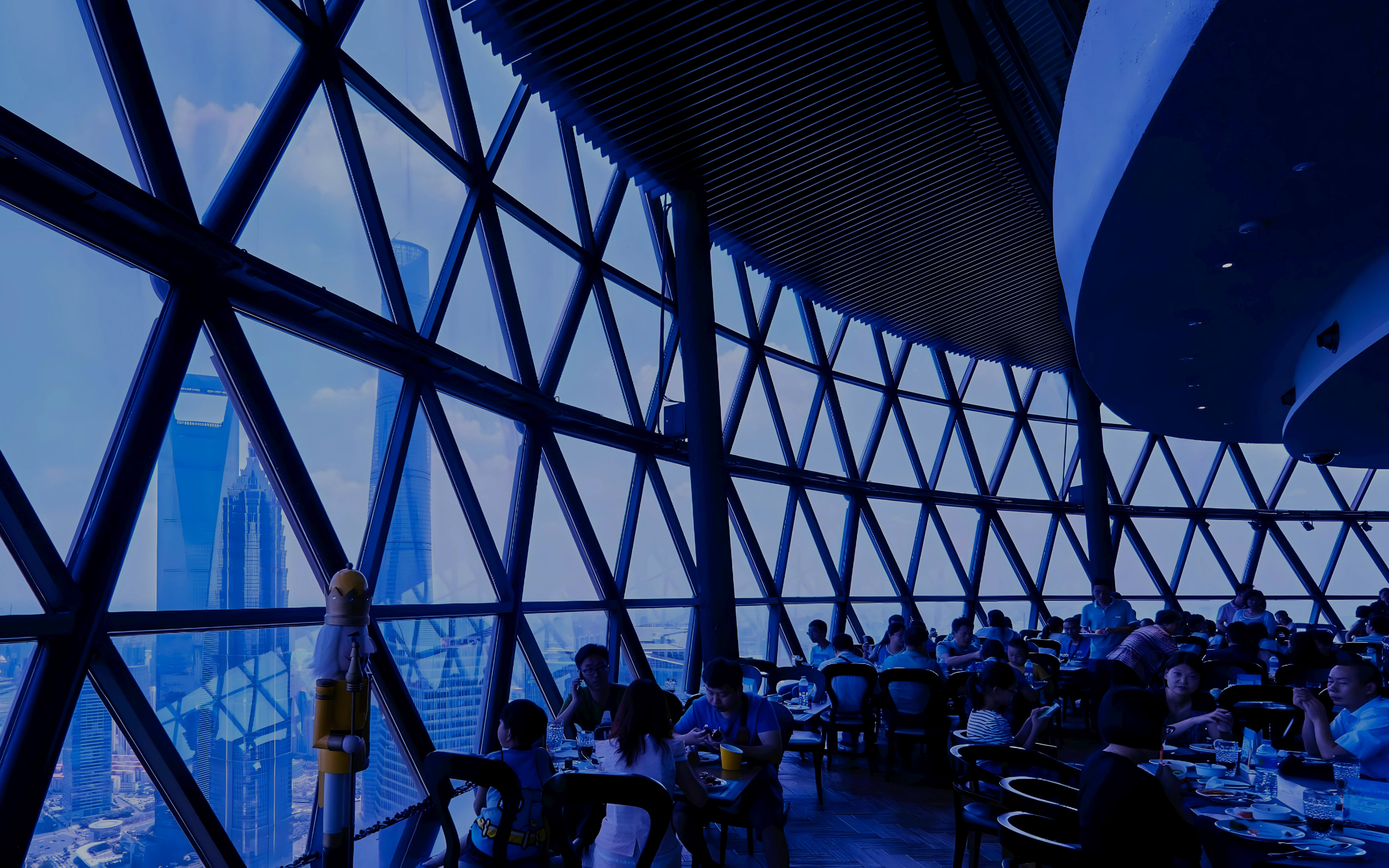 Dining experience at revolving restaurant, Oriental Pearl Tower, Shanghai with city skyline views.