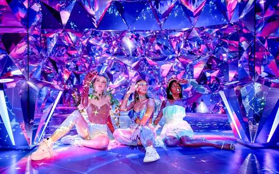 Visitors enjoying the colorful, reflective room at WONDR Experience.