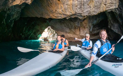 Kayakers exploring a cave on a Capri tour.