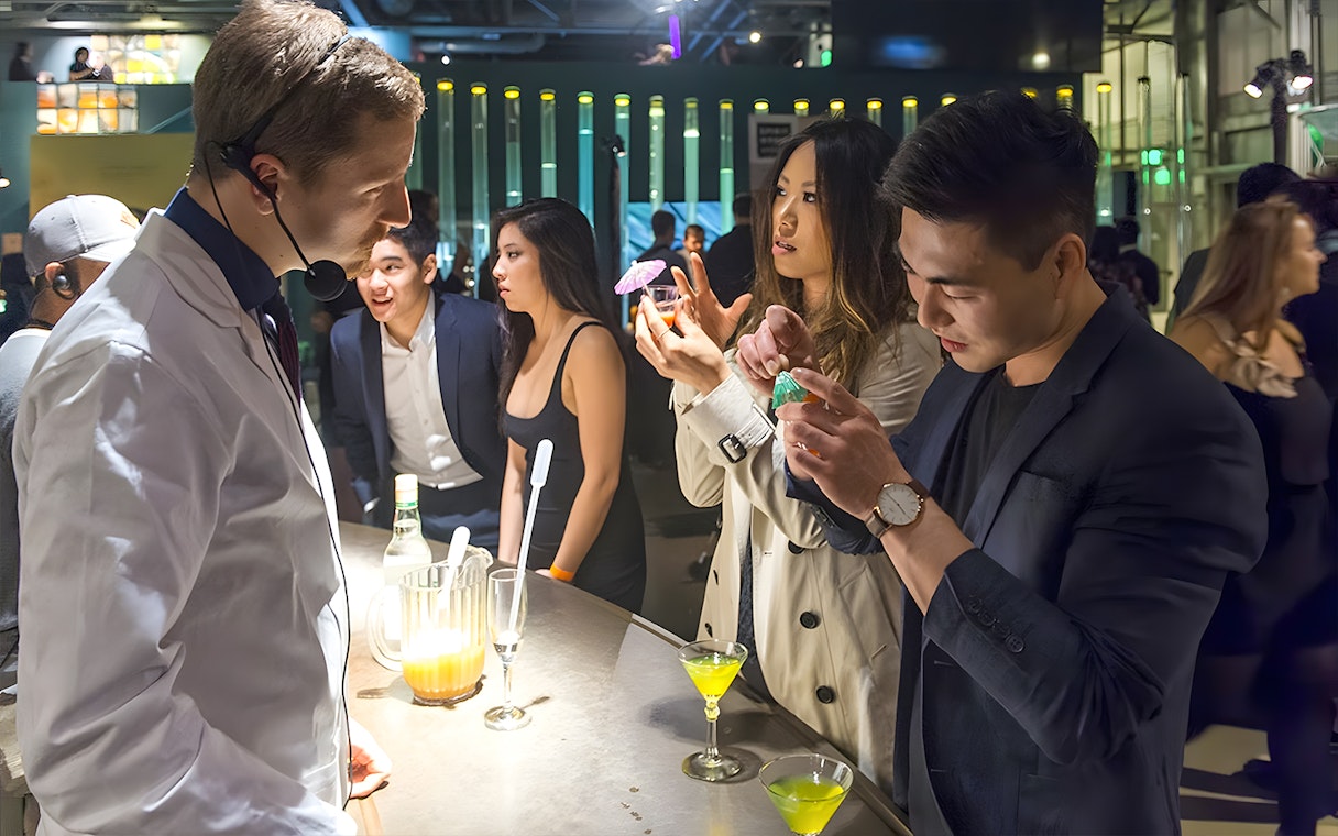 Guests interacting at a science-themed bar in the Exploratorium, San Francisco.