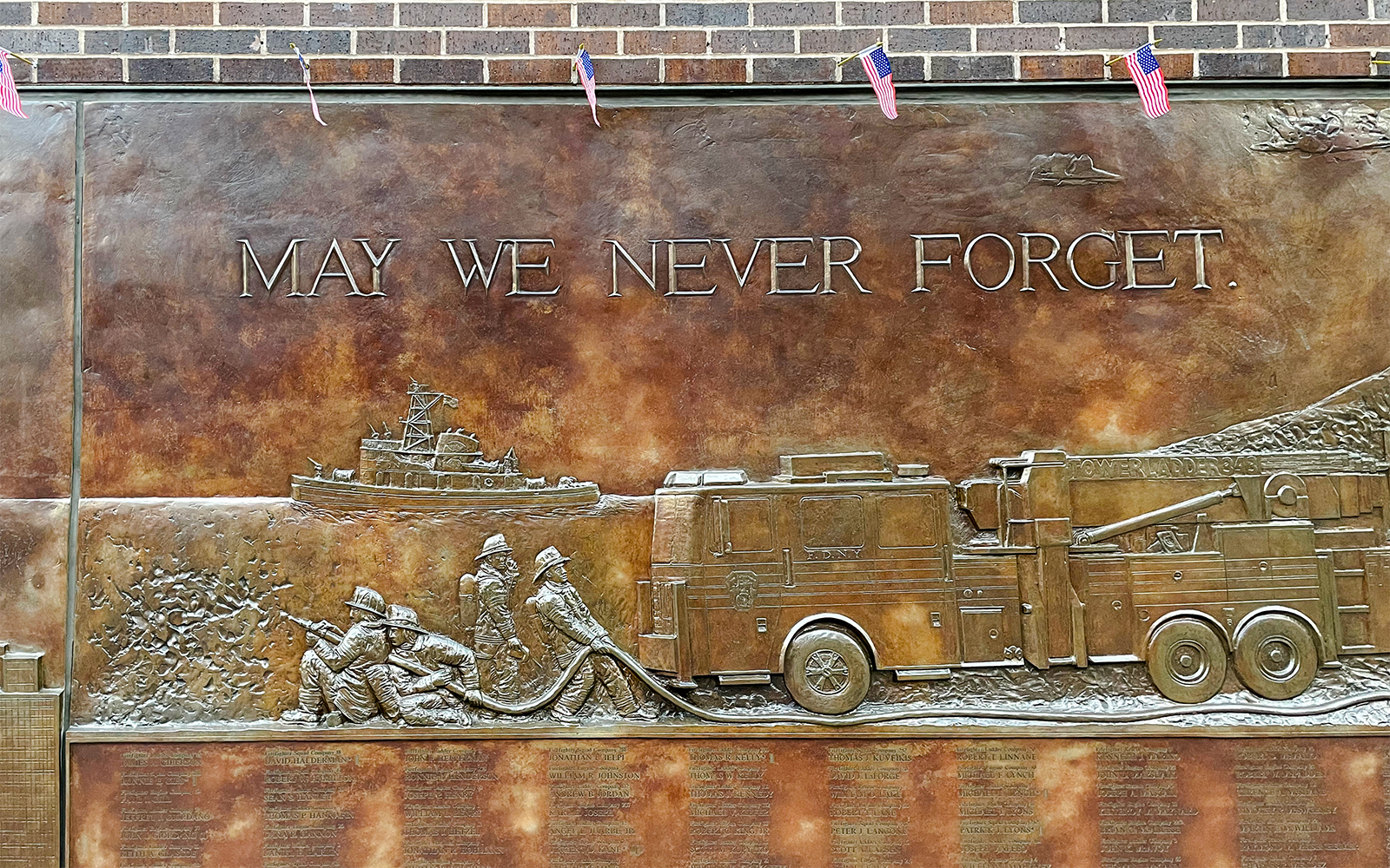 FDNY Memorial Wall with firefighters and fire truck relief, New York City.