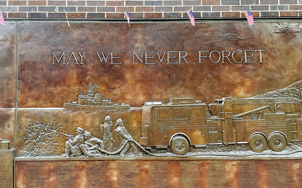 FDNY Memorial Wall with firefighters and fire truck relief, New York City.