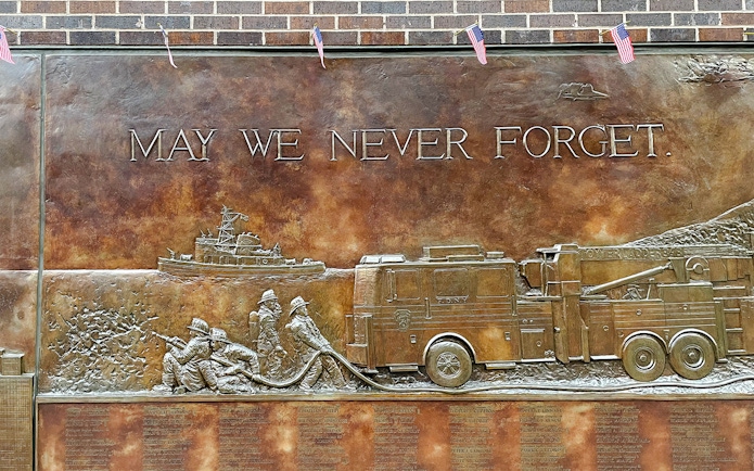 FDNY Memorial Wall with firefighters and fire truck relief, New York City.