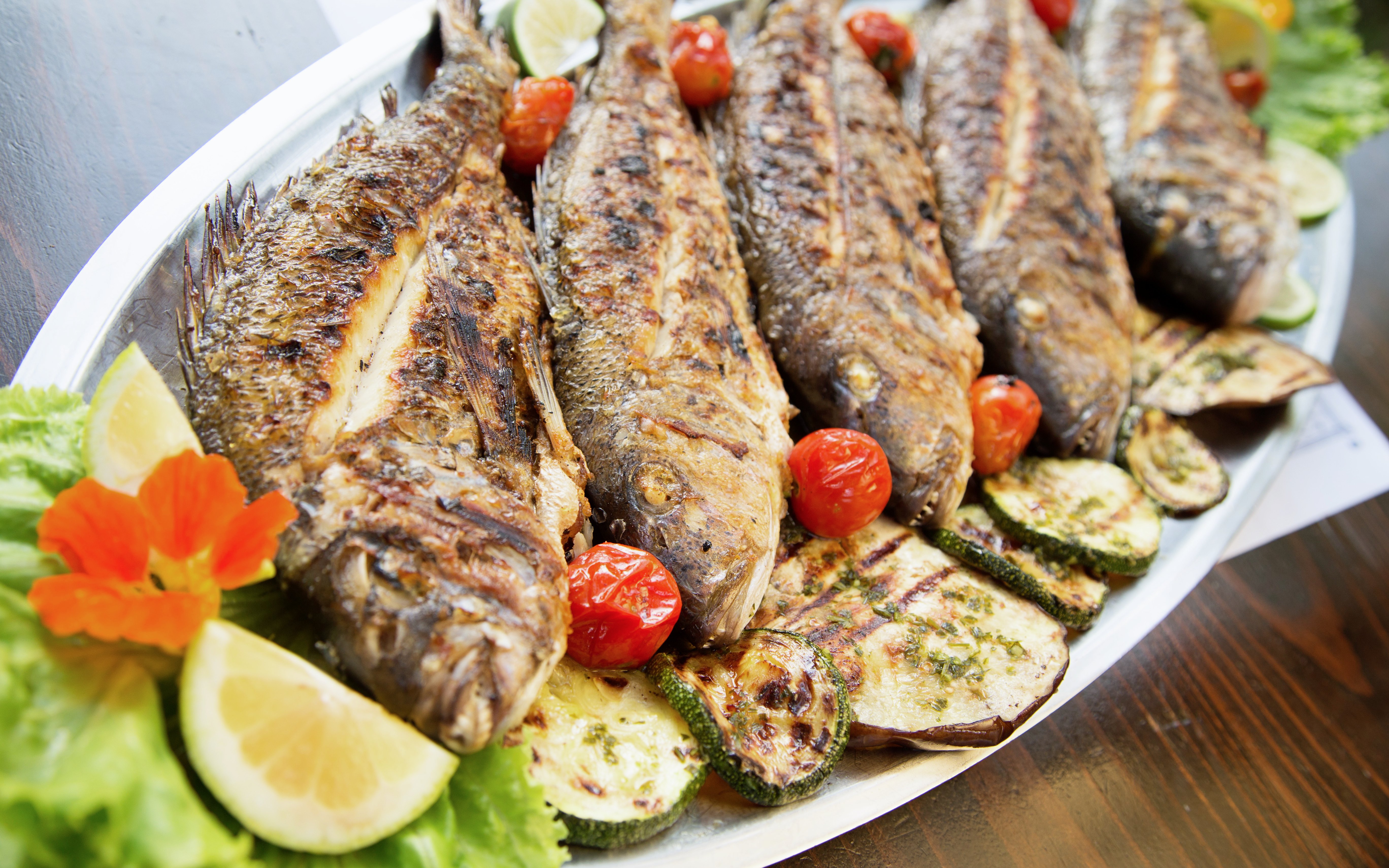 Grilled fish with vegetables in a konoba, Dalmatia, Croatia.