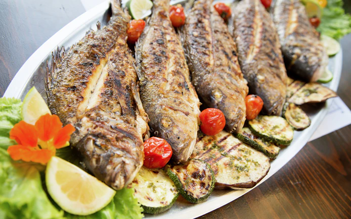 Grilled fish with vegetables in a konoba, Dalmatia, Croatia.